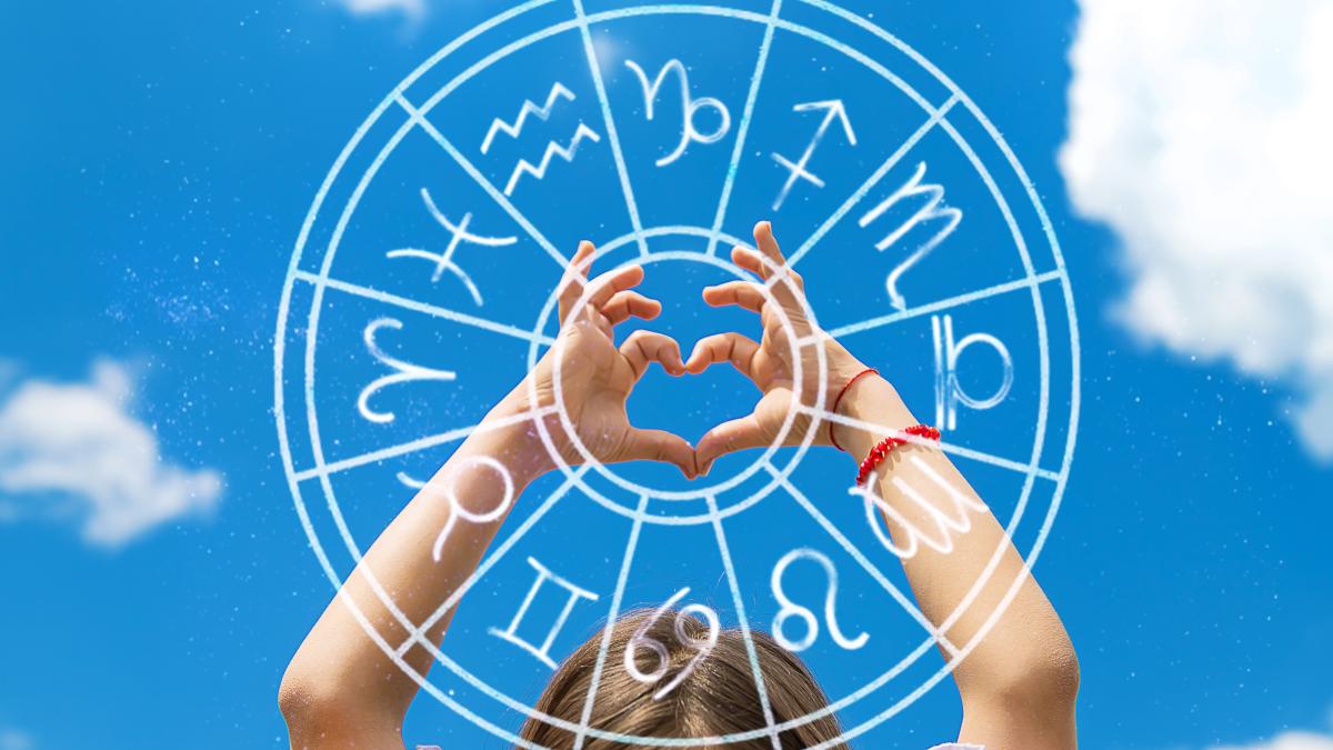 child-makes-heart-with-his-hands-against-sky-zodiac-sign-selective-focus_21238500